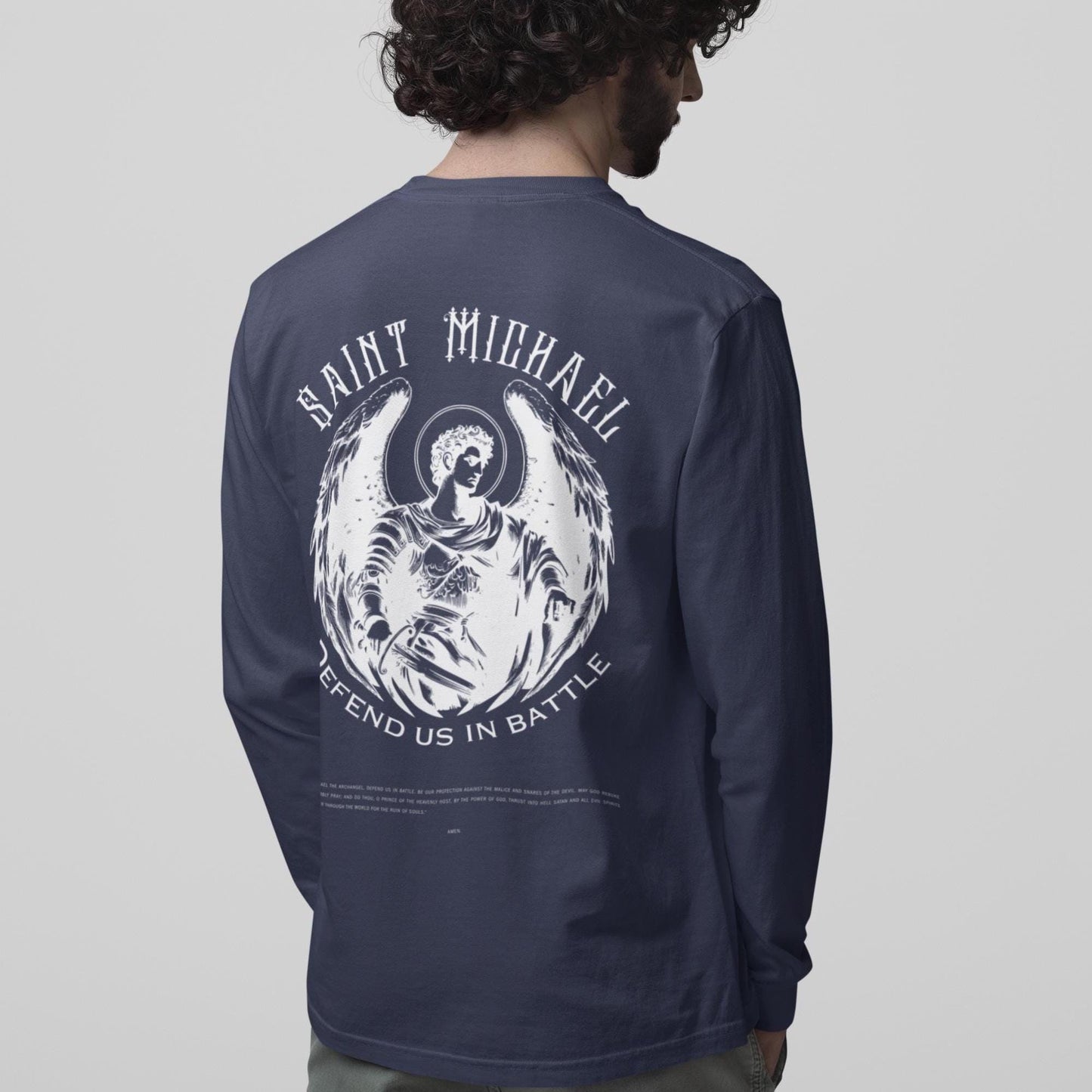 Navy long-sleeve shirt with 'Saint Michael' graphic on the back, worn by a person.