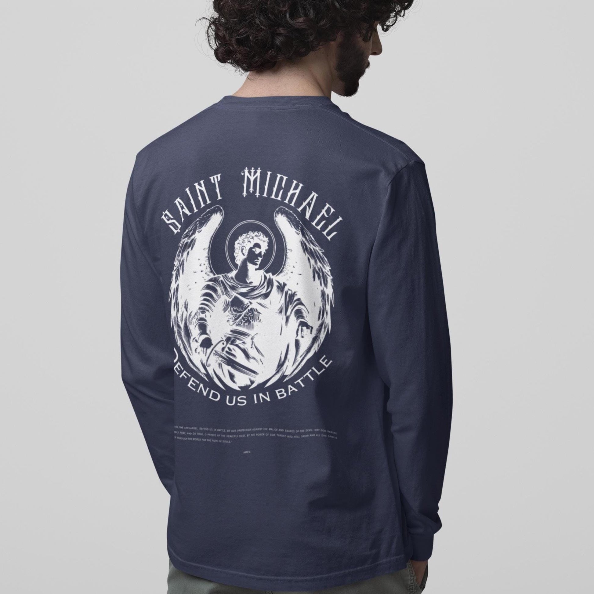 Navy long-sleeve shirt with 'Saint Michael' graphic on the back, worn by a person.